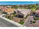 Gorgeous home highlighting meticulous landscaping, desert accents, lush turf, and paver driveway at 10013 Hunter Springs Dr, Las Vegas, NV 89134