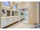 Primary bathroom featuring double sinks, quartz countertops, and walk-in shower at 10013 Hunter Springs Dr, Las Vegas, NV 89134