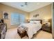 Bedroom with carpet flooring, white bedding and a large window at 10013 Hunter Springs Dr, Las Vegas, NV 89134