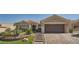 Charming home featuring a well-manicured front yard with desert landscaping and a paved driveway at 10013 Hunter Springs Dr, Las Vegas, NV 89134