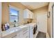 A laundry room features cabinets and a gray accent rug at 10013 Hunter Springs Dr, Las Vegas, NV 89134