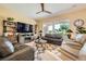 Spacious living room with ceiling fan, fireplace, and backyard views at 10013 Hunter Springs Dr, Las Vegas, NV 89134