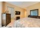 The main bedroom with dark furniture has natural light coming through the windows at 10013 Hunter Springs Dr, Las Vegas, NV 89134