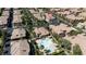 Community aerial view with a sparkling pool, clubhouse, palm trees, lush landscaping, and uniform rooftops at 10180 Delray Beach Ave # 202, Las Vegas, NV 89129