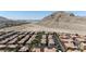 An aerial view of homes, near mountains, in a neighborhood that features well-designed streets and landscapes at 10180 Delray Beach Ave # 202, Las Vegas, NV 89129