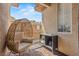 Outdoor patio with a comfortable wicker chair and a side table to hold belongings at 10180 Delray Beach Ave # 202, Las Vegas, NV 89129