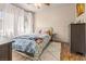 Comfortable bedroom featuring a large window, neutral walls, and plush rug; cozy and inviting at 10180 Delray Beach Ave # 202, Las Vegas, NV 89129