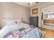 Well-lit bedroom featuring soft colors, a large window, and a view of the bathroom; peaceful and relaxing at 10180 Delray Beach Ave # 202, Las Vegas, NV 89129