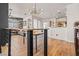 Open-concept dining room with stylish light fixture, clear chairs, and wood flooring at 10180 Delray Beach Ave # 202, Las Vegas, NV 89129