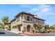 Attractive tan stucco condo building with well-maintained landscaping, multiple windows, and covered parking at 10180 Delray Beach Ave # 202, Las Vegas, NV 89129