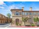 Attractive tan stucco condo building with well-maintained landscaping, multiple windows, and covered parking at 10180 Delray Beach Ave # 202, Las Vegas, NV 89129