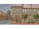 Exterior of a well-maintained apartment building with manicured landscaping and a charming entrance at 10180 Delray Beach Ave # 202, Las Vegas, NV 89129