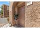 Welcoming front door with decorative planter, textured stucco wall, and clear unit number marking for easy access at 10180 Delray Beach Ave # 202, Las Vegas, NV 89129