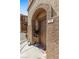 Charming front entrance with decorative plants, textured stucco exterior, and clear unit number signage at 10180 Delray Beach Ave # 202, Las Vegas, NV 89129