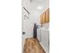 Functional laundry room with washer, dryer, ironing board, and overhead storage; efficient and well-organized at 10180 Delray Beach Ave # 202, Las Vegas, NV 89129