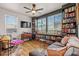 Cozy living room features a ceiling fan, built-in bookshelves, large windows, and comfortable seating at 10180 Delray Beach Ave # 202, Las Vegas, NV 89129