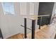 Contemporary staircase featuring black metal railings and wood accents, bathed in natural light at 10180 Delray Beach Ave # 202, Las Vegas, NV 89129