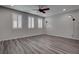 Open living room with wood-look floors and modern lighting features at 1040 Via Panfilo Ave, Henderson, NV 89011