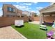A cozy backyard with a small trampoline, artificial grass, hardscape and covered patio area perfect for outdoor relaxation at 10829 Crestview Pointe Ave, Las Vegas, NV 89166
