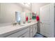 Bathroom featuring dual sinks, stylish mirror and vanity, providing ample space for morning routines at 10829 Crestview Pointe Ave, Las Vegas, NV 89166