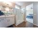Bright bathroom featuring a glass enclosed shower and doorway to the bedroom at 10829 Crestview Pointe Ave, Las Vegas, NV 89166