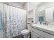 Well-lit bathroom featuring a shower-tub combo, stylish vanity and a decorative shower curtain at 10829 Crestview Pointe Ave, Las Vegas, NV 89166