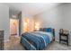 Bedroom has a blue bedspread, carpet, and neutral walls, with an ensuite bathroom at 10829 Crestview Pointe Ave, Las Vegas, NV 89166