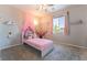 Bright bedroom with window, pink accents and soft carpet, perfect for a personal space at 10829 Crestview Pointe Ave, Las Vegas, NV 89166