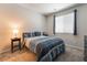 Cozy bedroom with a blue bedspread and a nightstand with a lamp at 10829 Crestview Pointe Ave, Las Vegas, NV 89166