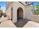 Inviting front entrance with an arched doorway and landscaped surroundings at 10829 Crestview Pointe Ave, Las Vegas, NV 89166