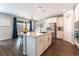 Bright kitchen features stainless steel appliances, white cabinets, and pendant lighting at 10829 Crestview Pointe Ave, Las Vegas, NV 89166