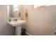 Small powder room with white pedestal sink, mirror, and neutral walls at 10829 Crestview Pointe Ave, Las Vegas, NV 89166