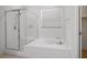 Bright bathroom featuring glass enclosed shower and large soaking tub with window at 11569 Velicata Ct, Las Vegas, NV 89138