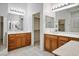 Bright bathroom featuring dual sink vanity with ample counter space, mirrors and modern lighting at 11569 Velicata Ct, Las Vegas, NV 89138