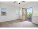 Cozy bedroom with two windows, a ceiling fan and access to a private balcony at 11569 Velicata Ct, Las Vegas, NV 89138