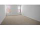 Spacious bedroom with neutral carpet and natural light from two windows at 11569 Velicata Ct, Las Vegas, NV 89138