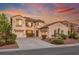 Charming two-story home with terracotta roof, three-car garage and beautiful sunset at 11569 Velicata Ct, Las Vegas, NV 89138