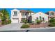 Charming two-story home with a terracotta tile roof, well-maintained landscaping, and a two-car garage at 11569 Velicata Ct, Las Vegas, NV 89138