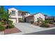 Charming two-story home with terracotta roof, three-car garage and well-maintained landscaping at 11569 Velicata Ct, Las Vegas, NV 89138