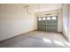 A simple two-car garage with a gray door at 11569 Velicata Ct, Las Vegas, NV 89138