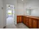 Hallway with wooden cabinets leading to a bedroom with a balcony at 11569 Velicata Ct, Las Vegas, NV 89138