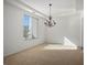 Bright living room with carpet flooring and large window at 11569 Velicata Ct, Las Vegas, NV 89138