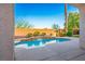 Backyard swimming pool with waterfall feature surrounded by lush landscaping at 11569 Velicata Ct, Las Vegas, NV 89138