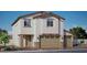 Charming two-story home featuring a two-car garage and neutral-toned stucco exterior, complemented by tasteful stone accents at 1206 Dre Harbor Pl. Ln # 84, North Las Vegas, NV 89084