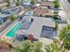 Expansive aerial view of the property featuring a large pool, patio, solar panels, and palm trees at 1589 Silver Mesa Way, Las Vegas, NV 89169