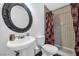 Pedestal sink and toilet in a vintage bathroom featuring checkered tile and a large mirror at 1589 Silver Mesa Way, Las Vegas, NV 89169