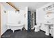 Bathroom featuring a claw foot tub, pedestal sink, shower and black tiled floor at 1589 Silver Mesa Way, Las Vegas, NV 89169