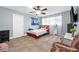 Cozy bedroom features neutral walls, ceiling fan, tile floors, and bright natural light at 1589 Silver Mesa Way, Las Vegas, NV 89169