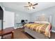 Inviting bedroom features a plush upholstered bed, hard floors, and lots of natural light at 1589 Silver Mesa Way, Las Vegas, NV 89169