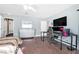 Bright bedroom featuring desk, vanity, and wall-mounted television and neutral colored walls at 1589 Silver Mesa Way, Las Vegas, NV 89169